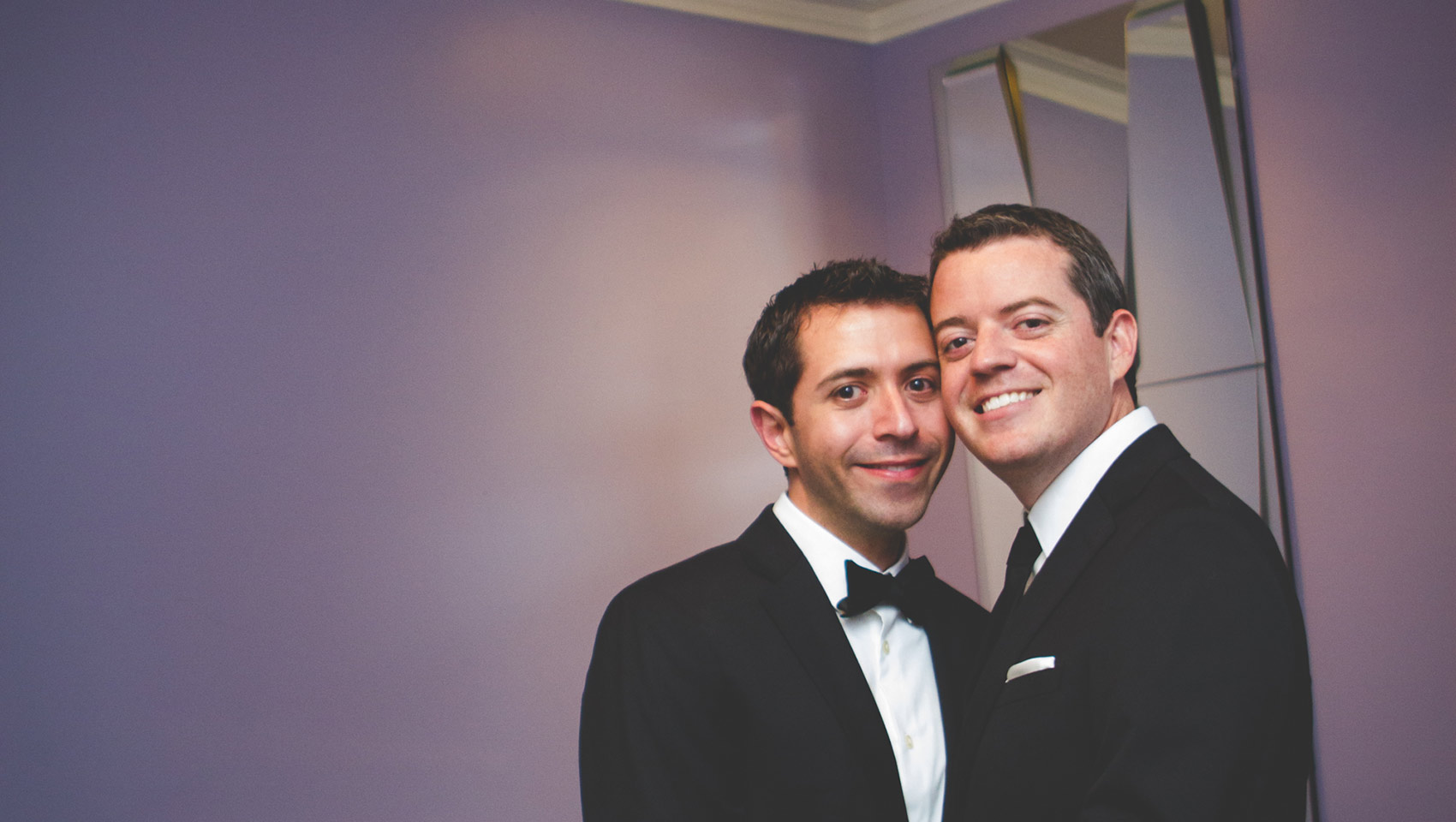 Two smiling grooms who just got married at Kimpton Hotel Palomar Philadlephia