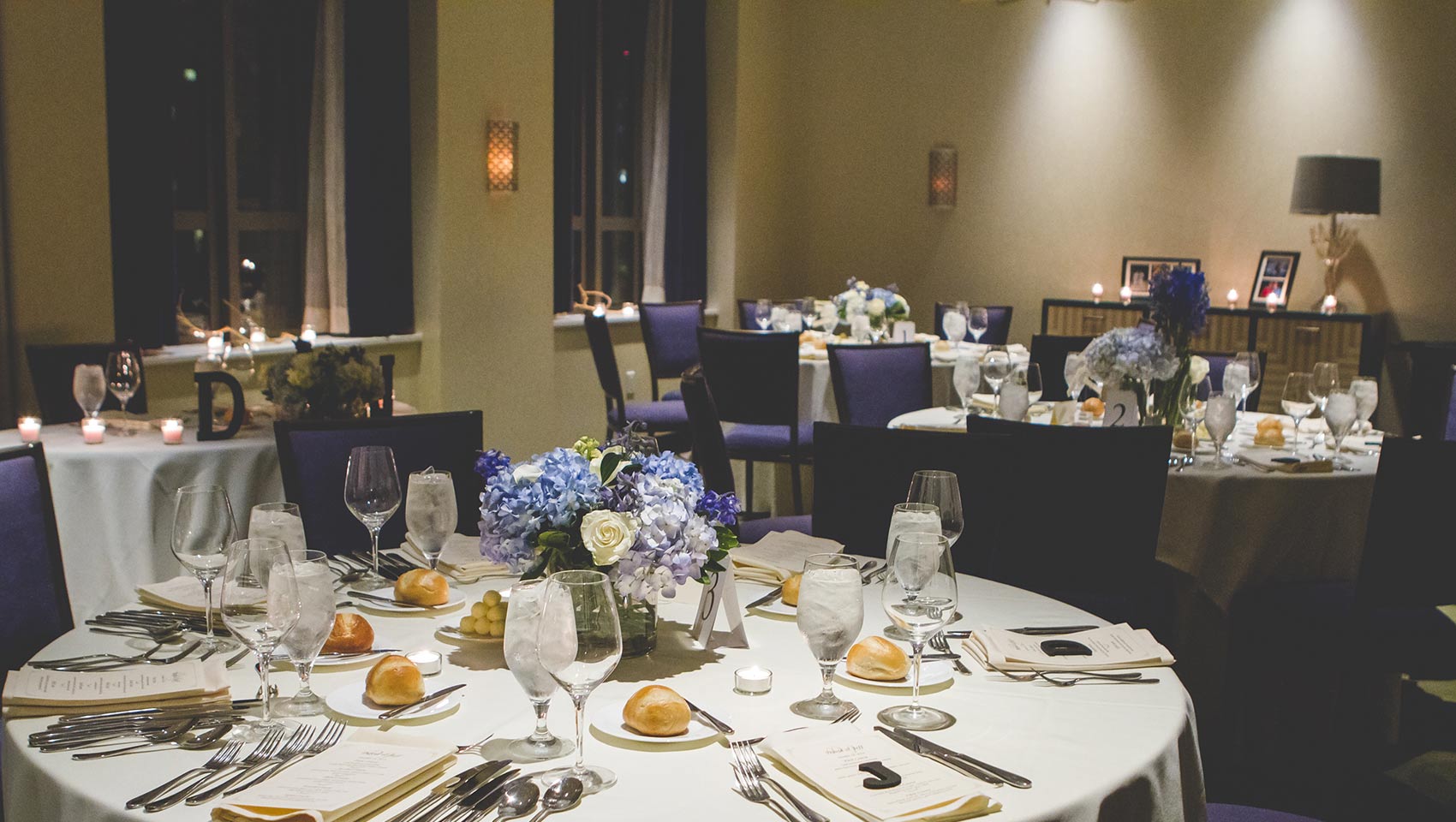 Round tables dressed for a wedding reception at Kimpton Hotel Palomar Philadelphia