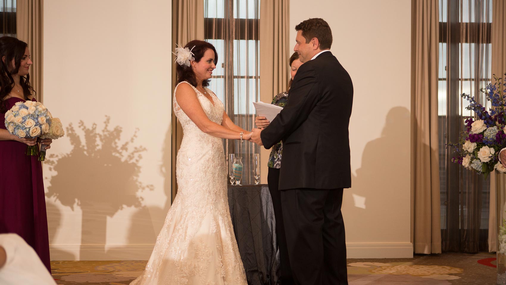 Bride and groom exchanging vows during ceremony at Kimpton Hotel Palomar Philadelphia
