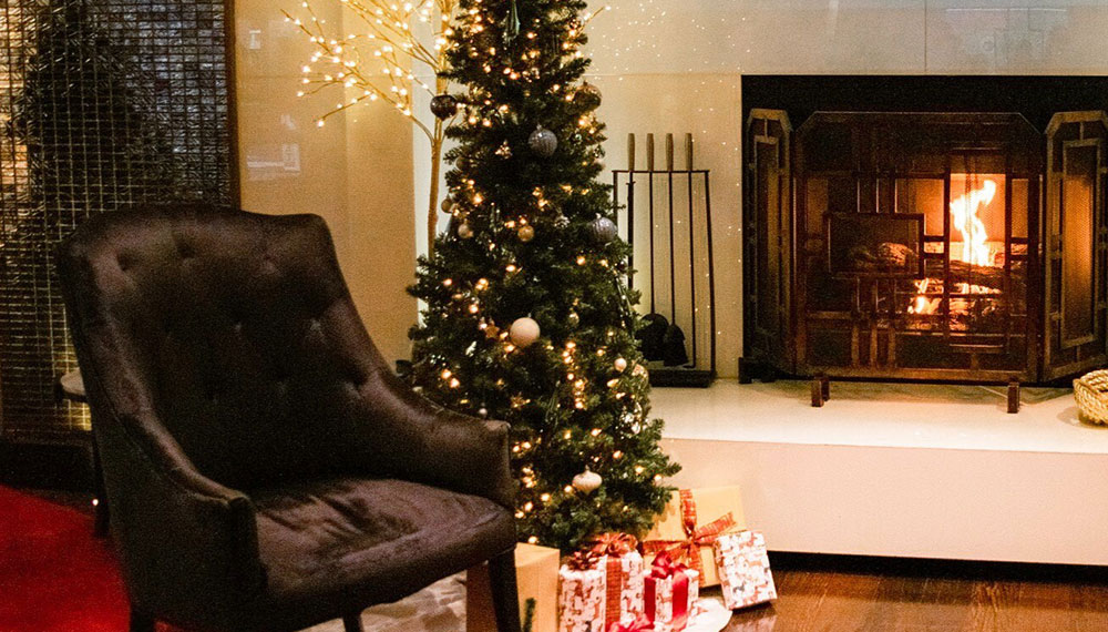 Holiday tree by fireplace in kimpton palomare philly lobby