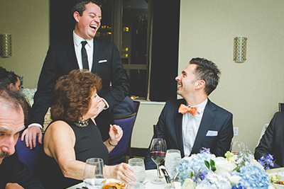 Groom interacting with guests at a table