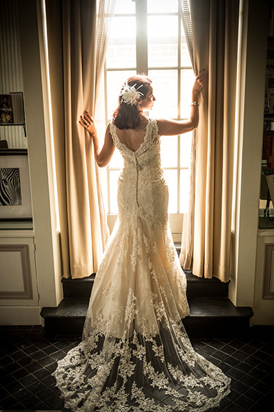 Bride posing in front of hotel window