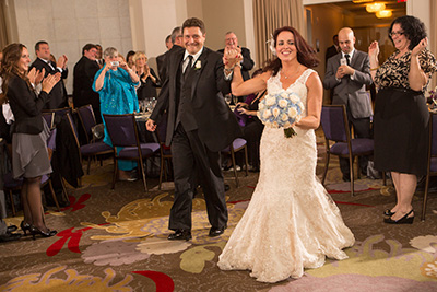 Bride and Groom holding hands entering room